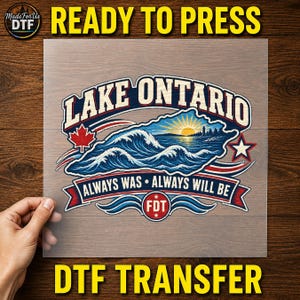 May include: A rectangular DTF transfer sheet featuring a graphic design with the text LAKE ONTARIO and ALWAYS WAS ALWAYS WILL BE. The illustration shows blue ocean waves, a yellow sun, a red maple leaf, a white star, and a red circle with FDT.