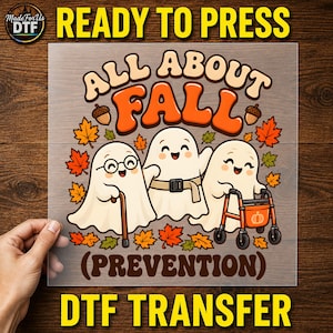 May include: A DTF transfer sheet featuring the text ALL ABOUT FALL and PREVENTION. The design shows three cartoon ghosts: one with glasses and a cane, one with a belt, and one with a walker, surrounded by orange and yellow autumn leaves and acorns.