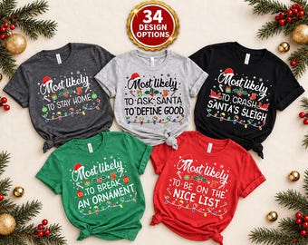 May include: Five short-sleeved t-shirts in dark grey, light grey, black, green, and red. Each shirt features a Christmas-themed graphic with the text Most likely to followed by unique phrases like stay home, ask Santa to define good, and more.