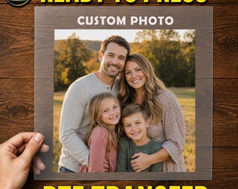 May include: A square DTF transfer sheet featuring a custom photo of a family of four, including two adults and two children, smiling outdoors. The text "CUSTOM PHOTO" is printed in white at the top centre of the transparent transfer film.