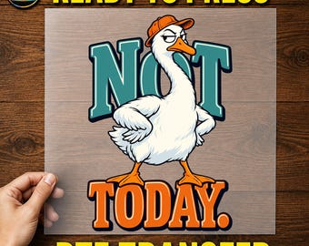 May include: A DTF transfer sheet featuring a white goose wearing an orange baseball cap, standing with hands on hips. The text NOT is in teal and TODAY is in orange, with a MadeForUs DTF logo in the corner. The design is on a clear film.