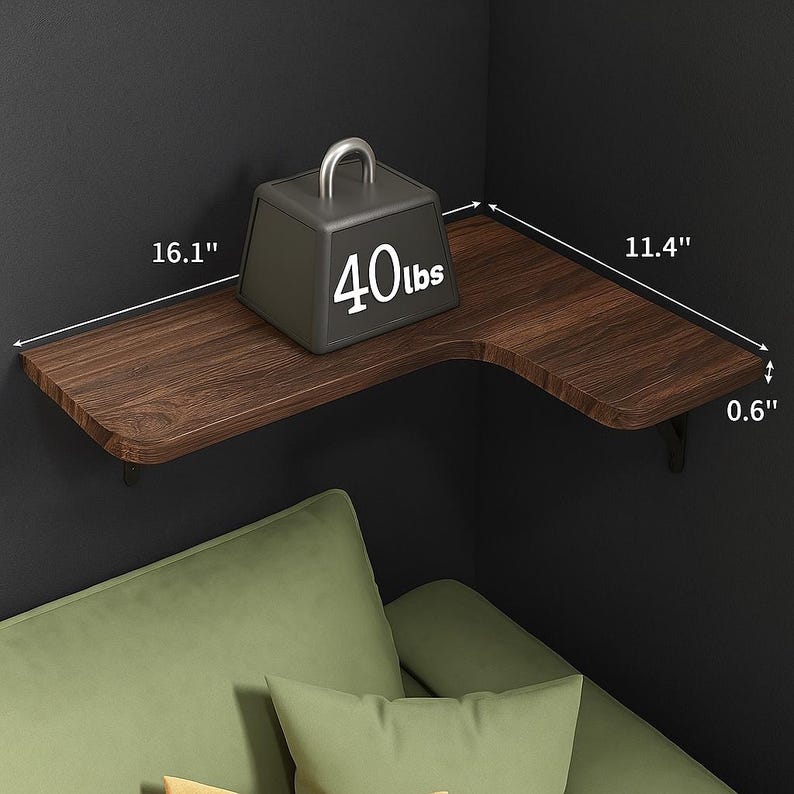 May include: A dark brown corner shelf with a wood grain finish, measuring 16.1" x 11.4" x 0.6". A gray weight with a silver handle and the text "40lbs" sits on the shelf. The shelf is mounted on a dark wall.