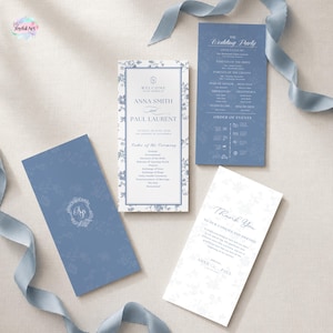May include: A set of three wedding program cards in dusty blue and white with floral borders and elegant typography. The cards display the wedding party, order of events, and a thank you note for Anna Smith and Paul Laurent, accented by a blue ribbon.