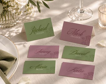 May include: Six rectangular place cards in sage green and dusty rose colors, featuring elegant script names including Richard Jackson, Mark Anderson, Jenny Morgan, David Jones, Alicia Miller, and Katie Hanes, with subtle floral line art illustrations.