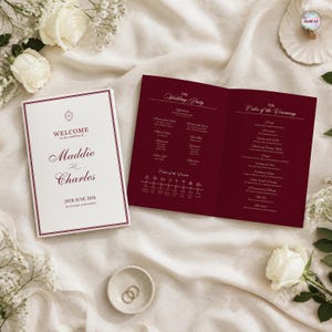 May include: A wedding program set featuring a white cover with burgundy text reading Welcome to the wedding of Maddie and Charles 28th June 2026 and an open burgundy interior booklet detailing the wedding party and order of ceremony.
