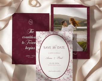 May include: A set of three wedding stationery cards in deep burgundy and white. One card features a photo of a couple, another displays the text The countdown to Forever begins, and the third is a Save the Date card with an oval frame and floral details.