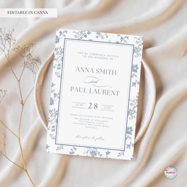 K&ouml;nnte beinhalten: Eine Hochzeitseinladung mit einem floralen Design in Blau- und Wei&szlig;t&ouml;nen. Die Einladung enth&auml;lt die Namen Anna Smith und Paul Laurent, das Datum 28. Juni 2026 und die Empfangsdetails. Der Text "EDITABLE IN CANVA" steht oben.