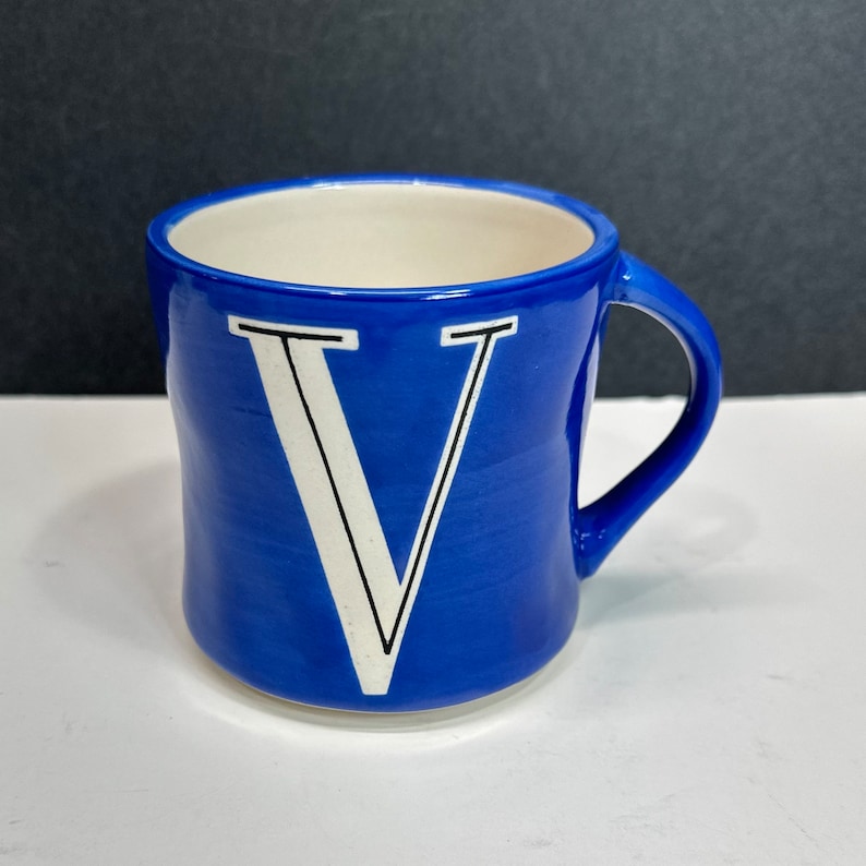 Blue and White Coffee Mug from Anthropologie- Monogram mug with the letter V, with handle and holds 12 ounces