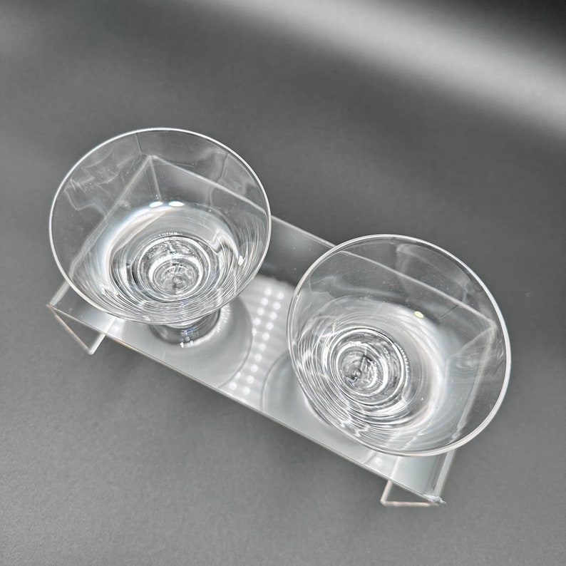 Peut inclure: Deux verres &agrave; boire en verre transparent avec un motif en spirale sur un support en acrylique transparent.