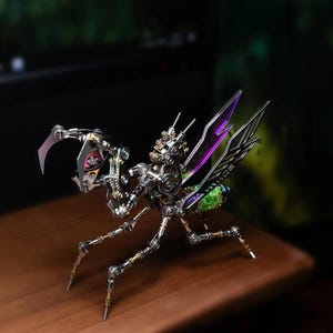 May include: A mechanical insect sculpture constructed from metallic gears, springs, and small components. It features articulated legs, a segmented body, and translucent purple wings. The head includes sharp, pincer-like appendages.