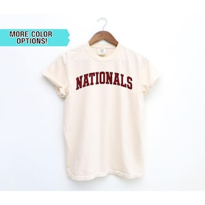 May include: A trio of ceramic mugs with a speckled, matte finish in cream, light grey, and dark grey. Each mug features a simple, minimalist design, ideal for tea or coffee.