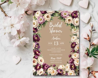 May include: A bridal shower invitation with a floral border of white, purple, and cream-colored flowers. The invitation features the text "Bridal Shower" and details for Amber's shower, including the date and time.