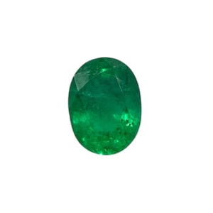 May include: Oval-cut emerald gemstone. The gem is a vibrant green color with visible internal inclusions. The shape is a classic oval, suitable for various jewelry designs. The gemstone is set against a white background.