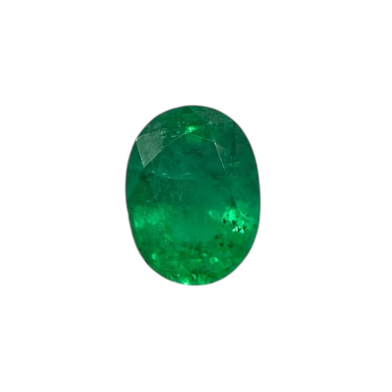 May include: Oval-cut emerald gemstone. The gem is a vibrant green color with visible internal inclusions. The shape is a classic oval, suitable for various jewelry designs. The gemstone is set against a white background.
