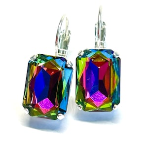 May include: A pair of iridescent rectangular earrings with silver-colored lever-back closures. The earrings feature a vibrant array of colors, including green, blue, purple, and yellow, creating a rainbow effect. The gemstones are set in a silver-toned metal.