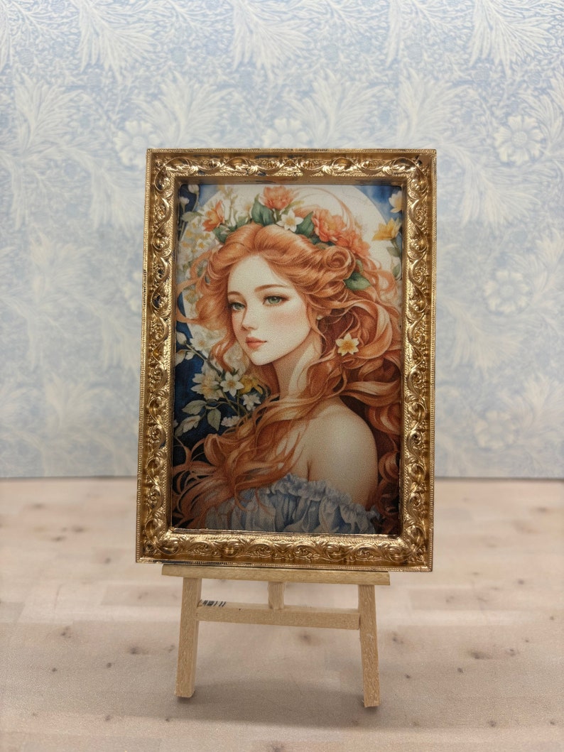 May include: A framed painting of a woman with long red hair wearing a flower crown. The painting is set on a wooden easel against a blue and white patterned background.