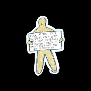 Könnte beinhalten: Eine gelbe Strichmännchenfigur hält ein Schild mit der Aufschrift "SIEH DIR AN! DU MACHST ES. SELBST MIT ALL DEM, WAS DU DURCHMACHST. ICH WEISS, ES WAR NICHT LEICHT UND ICH BIN SO STOLZ AUF DICH".
