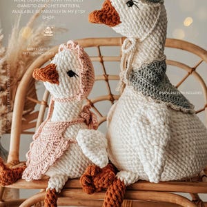 May include: Two crocheted goose dolls, one large and one small, are seated on a wicker chair. The larger goose wears a bonnet and shawl, while the smaller one has a bonnet and bib. The geese are white with orange beaks and feet. Text on the image indicates patterns are available.