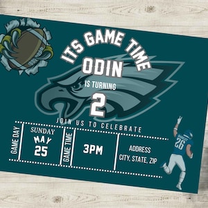 May include: Green and white football-themed birthday invitation for a boy turning two. The invitation features a football player, a football, and a Philadelphia Eagles logo. The text on the invitation reads "It's Game Time Odin is turning 2. Join us to celebrate Sunday May 25 3PM Address City, State, Zip".