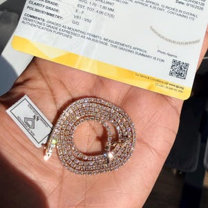 May include: A 14 karat yellow gold necklace with round brilliant laboratory grown diamonds, accompanied by an International Gemological Institute grading summary report stating a 15 inch length and a total weight of 4.00 carats.