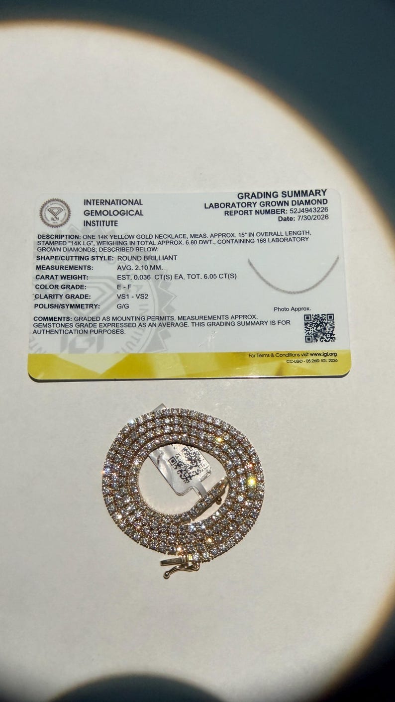 May include: A 14k yellow gold necklace with 168 laboratory grown diamonds, accompanied by an International Gemological Institute grading summary card. The necklace is 15 inches in length, with round brilliant diamonds averaging 2.10 mm.