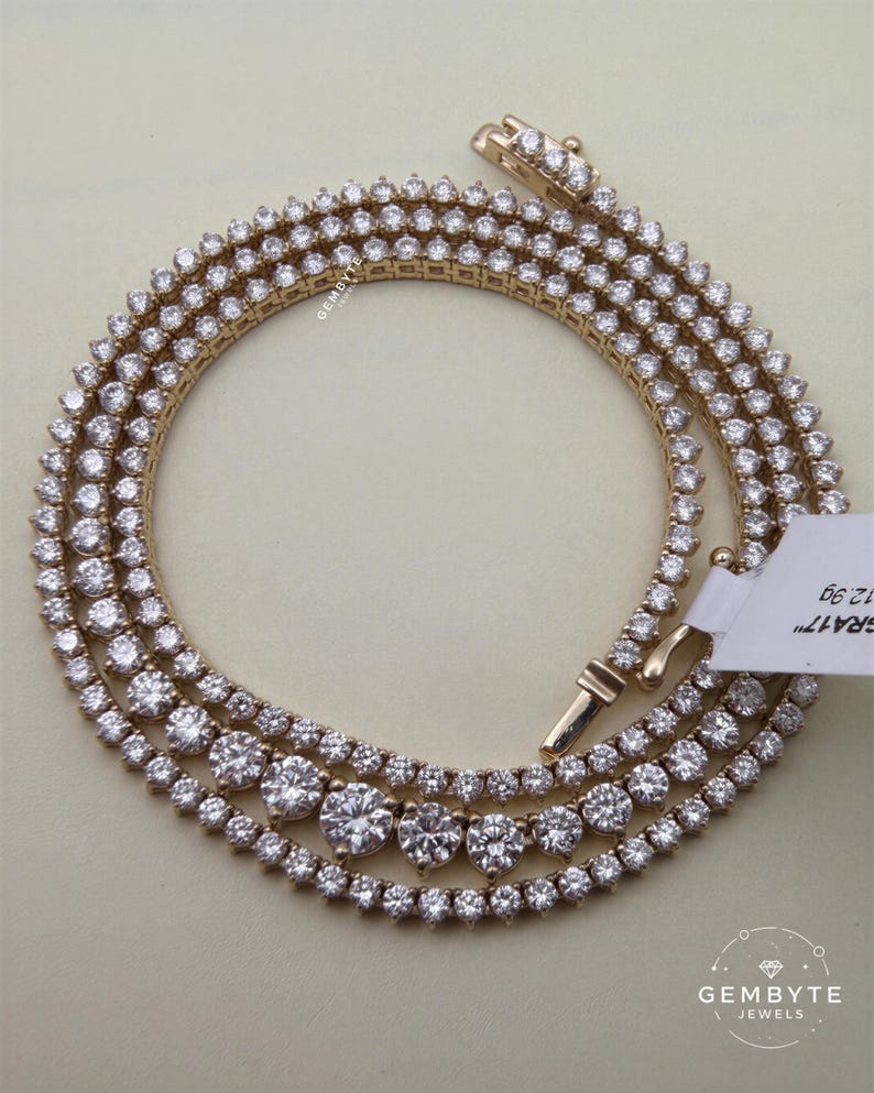 A gold necklace with numerous large diamonds arranged in a circular pattern.
