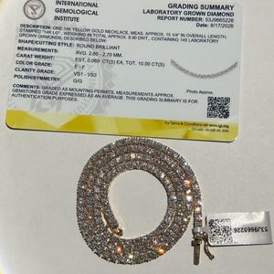 May include: A 14k yellow gold tennis necklace featuring 145 round brilliant laboratory-grown diamonds with a total weight of 10.00 carats. The necklace measures 15 1/4 inches in length and is accompanied by an International Gemological Institute report.
