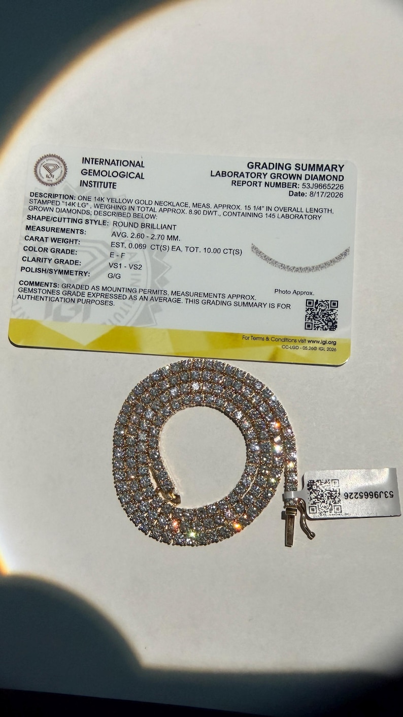 May include: A 14k yellow gold tennis necklace featuring 145 round brilliant laboratory-grown diamonds with a total weight of 10.00 carats. The necklace measures 15 1/4 inches in length and is accompanied by an International Gemological Institute report.