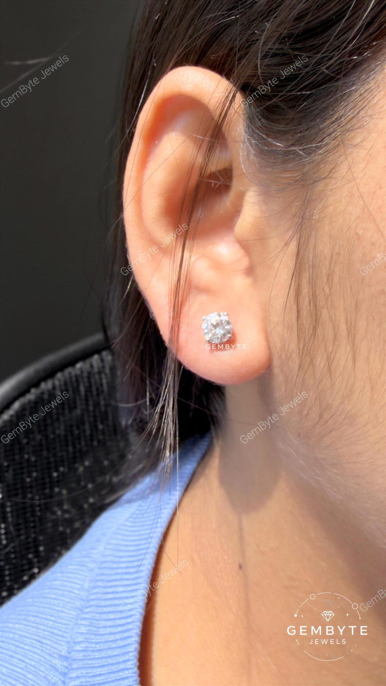 A close-up view of a person's ear adorned with a diamond earring.