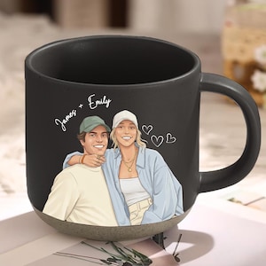 May include: Black ceramic mug with a light brown base. The mug features a cartoon illustration of a couple with the names "James + Emily" written above them. Two small heart illustrations are also present.