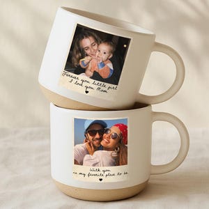 May include: Two white ceramic mugs stacked on top of each other. Each mug has a photo printed on it. The top mug has a photo of a mother and child with the text "Forever you little girl I love you Mom". The bottom mug has a photo of a couple with the text "With you is my favorite place to be."