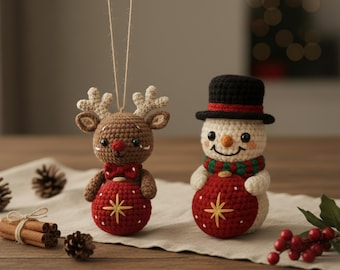 May include: Two crocheted Christmas ornaments: a reindeer and a snowman. The reindeer is brown with a red bow tie and a red ball with a gold star. The snowman has a black hat, a green and red scarf, and a red ball with a gold star.