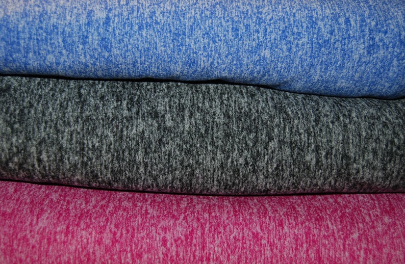 May include: Three fabric swatches in different colors: a bright blue, a dark gray, and a bright pink. The fabric has a speckled, textured appearance.
