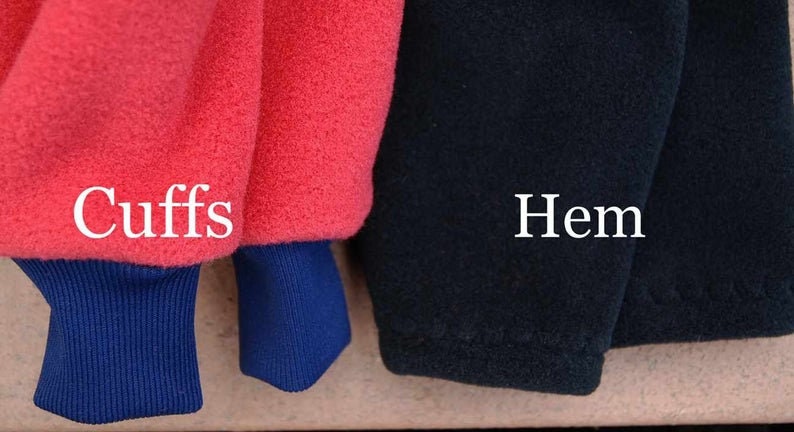 May include: Close-up of a red fleece jacket with blue cuffs and a black fleece jacket with a hem. The text "Cuffs" is written on the red jacket and the text "Hem" is written on the black jacket.