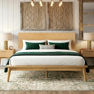 May include: A light wood bed frame with a chevron-patterned headboard, featuring a white mattress, a dark green throw blanket, two dark green rectangular pillows, and a small gray patterned accent pillow, flanked by two wooden nightstands.