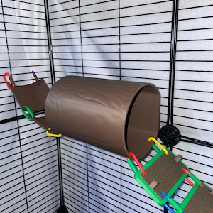May include: A brown plastic tunnel shaped like a hollow log, suspended between two small brown platforms with wood grain textures. The platforms are connected to the tunnel and the cage walls by colorful red, green, blue, and yellow plastic links.