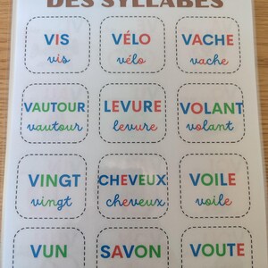 May include: A colorful educational game for learning French syllables. The game features 12 squares with different French words, each with a different color scheme. The words are: "vis", "v&eacute;lo", "vache", "vautour", "levure", "volant", "vingt", "cheveux", "voile", "vun", "savon", and "voute".