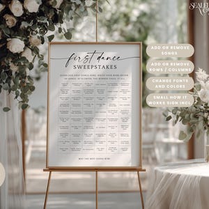 May include: A rectangular wedding sign in a gold frame on a stand, titled First Dance Sweepstakes. The white sign features a grid of song titles, instructions to guess the first dance song, and the text May the best guess win at the bottom.