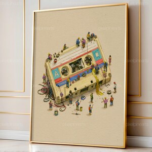 May include: A framed art print featuring a beige cassette tape with a blue and red stripe, labeled with the letter A. Numerous tiny figures in colorful work clothes are depicted interacting with the tape, pulling out magnetic ribbon.
