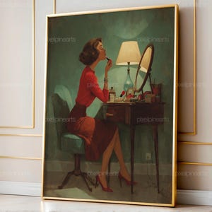 May include: A framed vintage-style print depicts a woman applying lipstick at a vanity. She wears a red blouse and skirt, seated on a teal chair. The scene includes a lamp, mirror, and makeup items, all in a room with a teal wall.