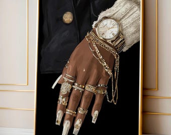 May include: A framed artwork featuring a hand adorned with gold jewelry, including rings, bracelets, and a wristwatch. The hand has long, white fingernails. The background is black, with a glimpse of a black jacket and a white sweater sleeve.