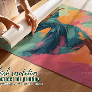 May include: An abstract art print featuring a dancer in a flowing teal dress against a backdrop of pink, orange, and green hues. The print is being unrolled, revealing the artwork. The text on the print says "high resolution" and "available in different sizes."