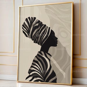 Könnte beinhalten: Gerahmter Kunstdruck mit einer Silhouette einer Person mit gestreiftem Kopftuch und Oberteil. Das Kunstwerk ist hauptsächlich in Schwarz-Weiß gehalten, mit einem neutralen Hintergrund und einem goldenen Rahmen. Das Bild vermittelt kulturelles Erbe und künstlerischen Ausdruck.
