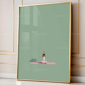 May include: A framed art print featuring a minimalist illustration of a person in a yoga pose on a pink mat. The figure is in white against a muted green background. The frame is gold.