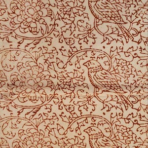 May include: Cream fabric with a repeating pattern of birds, flowers, and foliage in reddish-brown. The design features detailed outlines, creating a vintage aesthetic. The pattern is suitable for textiles.