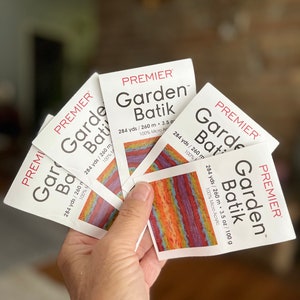 May include: Five skeins of Premier Garden Batik yarn in a rainbow of colors. Each skein is 284 yards / 260 meters and 3.5 ounces / 100 grams. The yarn is 100% micro acrylic.