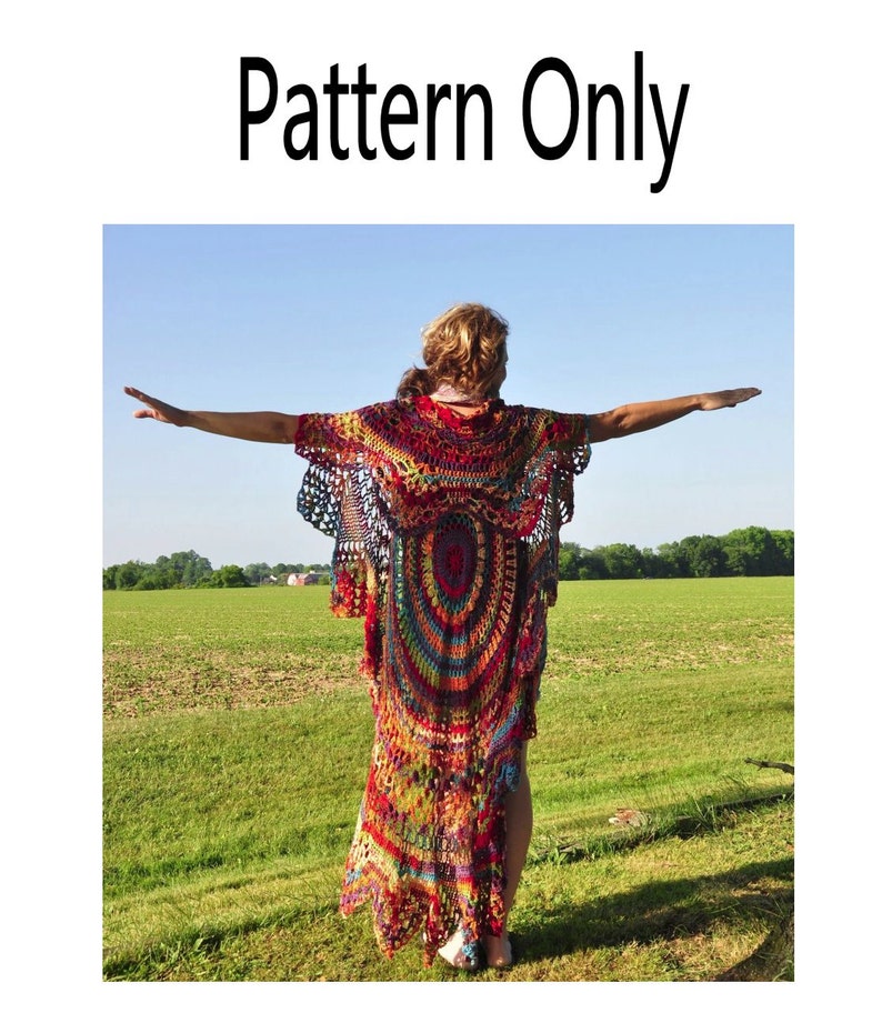 May include: A colorful crochet top with a long, flowing design. The top is made with a variety of colors, including red, orange, yellow, green, blue, and purple. The top is shown being worn by a person standing in a field.