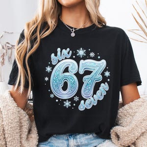 May include: A white ceramic mug with a black handle and the text "But First, Coffee" in a bold, black font. The mug is filled with a dark liquid, likely coffee, and rests on a light-coloured surface.