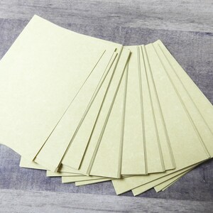 May include: A stack of 12 sheets of light green paper. The paper has a textured surface and is slightly translucent.