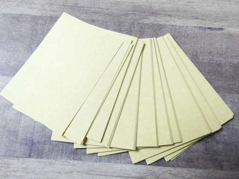 May include: A stack of 12 sheets of light green paper. The paper has a textured surface and is slightly translucent.